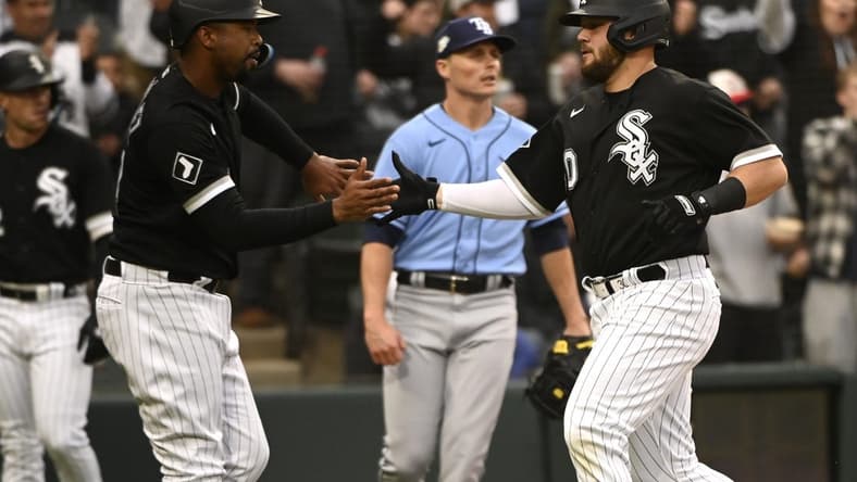 Apr 29, 2023; Chicago, Illinois, USA;  Chicago White Sox designated hitter Eloy Jimenez (74), left, and Chicago White Sox third baseman Jake Burger (30) high five after scoring against the Tampa Bay Rays during the second inning at Guaranteed Rate Field. Mandatory Credit: Matt Marton-USA TODAY Sports