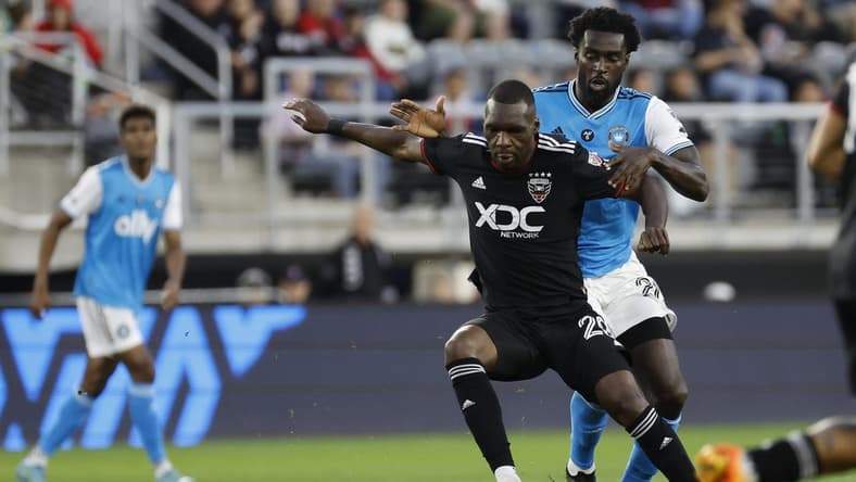 Apr 29, 2023; Washington, District of Columbia, USA; D.C. United forward Christian Benteke (20) and Charlotte FC midfielder Derrick Jones (20) battle for the ball in the first half at Audi Field. Mandatory Credit: Geoff Burke-USA TODAY Sports
