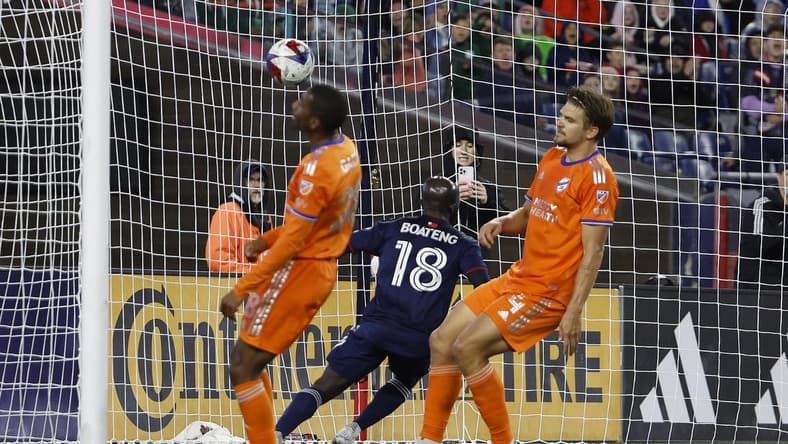Apr 29, 2023; Foxborough, Massachusetts, USA; FC Cincinnati defender Nick Hagglund (4) and defender Ray Gaddis (28) turn away as New England Revolution midfielder Ema Boateng (18) scores during the first half at Gillette Stadium. Mandatory Credit: Winslow Townson-USA TODAY Sports