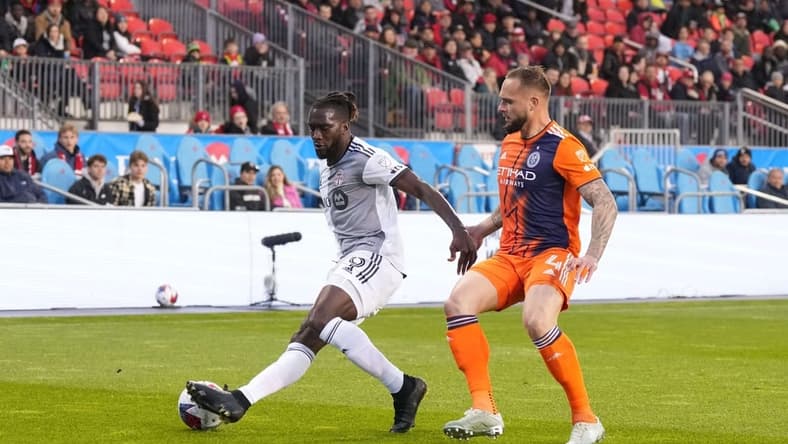 Apr 29, 2023; Toronto, Ontario, CAN; New York City FC defender Maxime Chanot (4) fights for ball possession against Toronto FC forward Charles Sapong (9) during the first half at BMO Field. Mandatory Credit: Nick Turchiaro-USA TODAY Sports