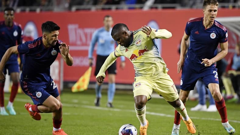 Apr 29, 2023; Chicago, Illinois, USA; New York Red Bulls forward Elias Manoel (11) battles for the ball against Chicago Fire defender Mauricio Pineda (22) during the first half at Soldier Field. Mandatory Credit: Jon Durr-USA TODAY Sports