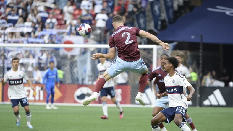 Apr 29, 2023; Vancouver, British Columbia, CAN;  Colorado Rapids defender Keegan Rosenberry (2) jumps to control the all against the Vancouver Whitecaps FC during the first half at BC Place. Mandatory Credit: Anne-Marie Sorvin-USA TODAY Sports