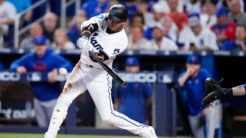 Apr 30, 2023; Miami, Florida, USA; Miami Marlins second baseman Luis Arraez (3) hits a single against the Chicago Cubs during the fourth inning at loanDepot Park. Mandatory Credit: Rich Storry-USA TODAY Sports