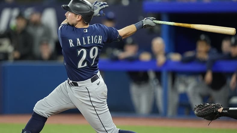 Apr 30, 2023; Toronto, Ontario, CAN; Seattle Mariners catcher Cal Raleigh (29) hits a two run home run against the Toronto Blue Jays during the tenth inning at Rogers Centre. Mandatory Credit: John E. Sokolowski-USA TODAY Sports