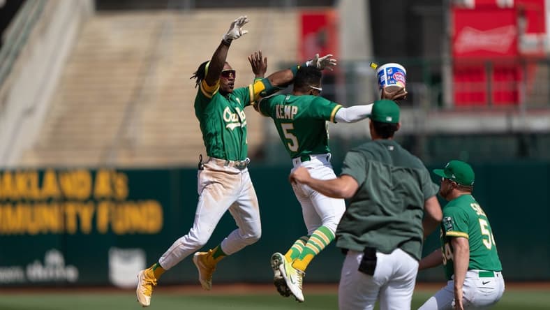 Apr 30, 2023; Oakland, California, USA;  Oakland Athletics second baseman Tony Kemp (5) celebrates with center fielder Esteury Ruiz (1) after defeating the Cincinnati Reds with a walk off single at RingCentral Coliseum. Mandatory Credit: Stan Szeto-USA TODAY Sports