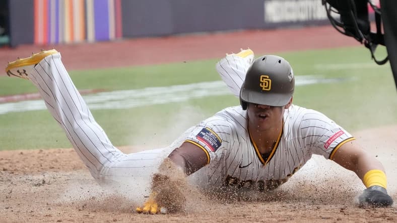 Apr 30, 2023; Mexico City, Mexico; San Diego Padres left fielder Juan Soto (22) slides into home plate to score in the eighth inning after the game during a MLB World Tour game at Estadio Alfredo Harp Helu. Mandatory Credit: Kirby Lee-USA TODAY Sports