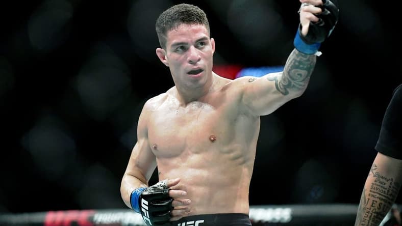 Jul 20, 2019; San Antonio, TX, USA; Felipe Colares (blue gloves) after his win over Domingo Pilarte (not pictured) during UFC Fight Night at AT&T Center. Colares won the fight. Mandatory Credit: Adam Hagy-USA TODAY Sports