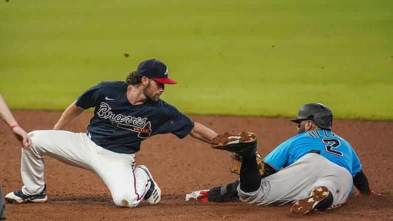 Jul 21, 2020; Cumberland, Georgia, USA; Miami Marlins second baseman Jonathan Villar (2) steals second base behind Atlanta Braves shortstop Charlie Culberson (8) during the sixth inning at Truist Park. Mandatory Credit: Dale Zanine-USA TODAY Sports