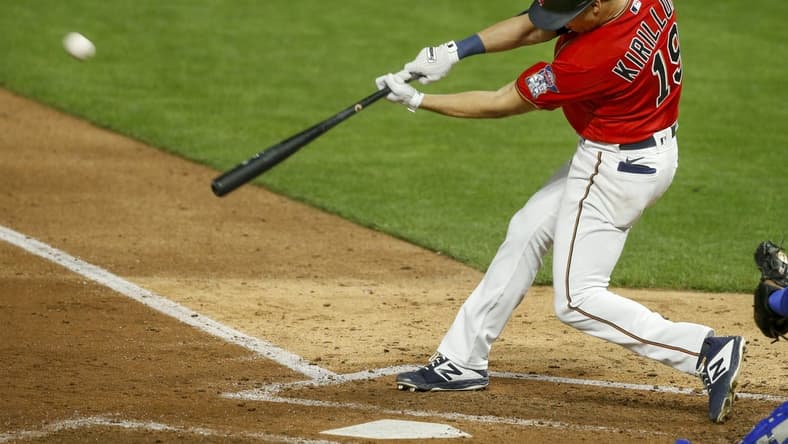 Apr 30, 2021; Minneapolis, Minnesota, USA; Minnesota Twins first baseman Alex Kiriloff (19) hits a solo home run against the Kansas City Royals manager Mike Matheny in the fifth inning at Target Field. Mandatory Credit: Bruce Kluckhohn-USA TODAY Sports