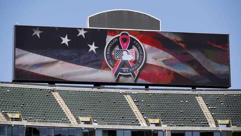 Sep 11, 2021; Oakland, California, USA; The main scoreboard displays the logo to commemorate 9/11 before the game between the Oakland Athletics and the Texas Rangers at RingCentral Coliseum. Mandatory Credit: Darren Yamashita-USA TODAY Sports