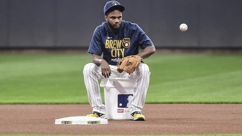 Oct 7, 2021; Milwaukee, WI, USA; Milwaukee Brewers infielder Pablo Reyes gathers balls during NLDS workouts. Mandatory Credit: Benny Sieu-USA TODAY Sports