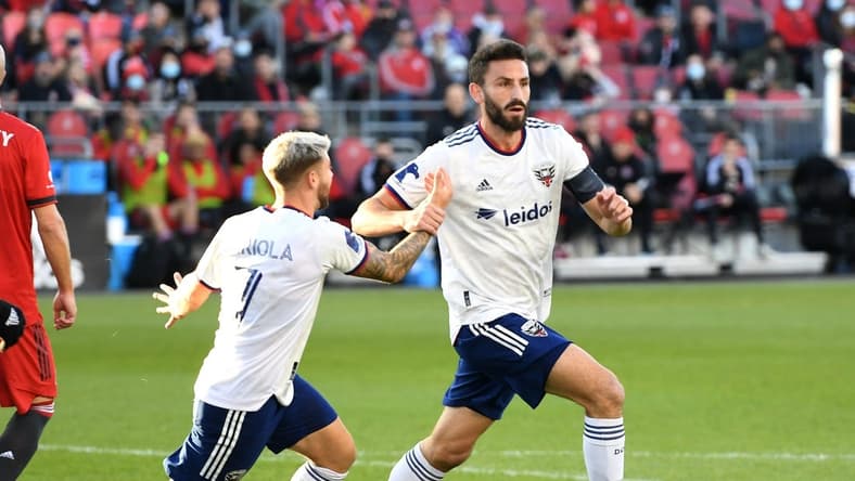 Nov 7, 2021; Toronto, Ontario, CAN;   DC United defender Steven Birnbaum (15) celebrates with forward Paul Arriola (7) after scoring on a header against Toronto FC in the first half at BMO Field. Mandatory Credit: Dan Hamilton-USA TODAY Sports