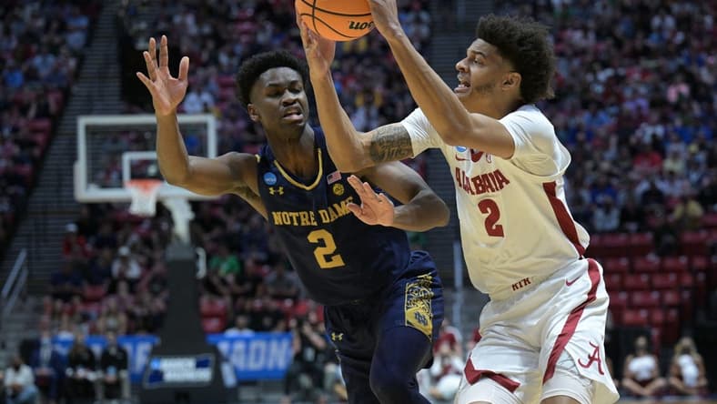 Mar 18, 2022; San Diego, CA, USA; Alabama Crimson Tide forward Darius Miles (2) controls the ball against Notre Dame Fighting Irish guard Trey Wertz (2) in the first half during the first round of the 2022 NCAA Tournament at Viejas Arena. Mandatory Credit: Orlando Ramirez-USA TODAY Sports