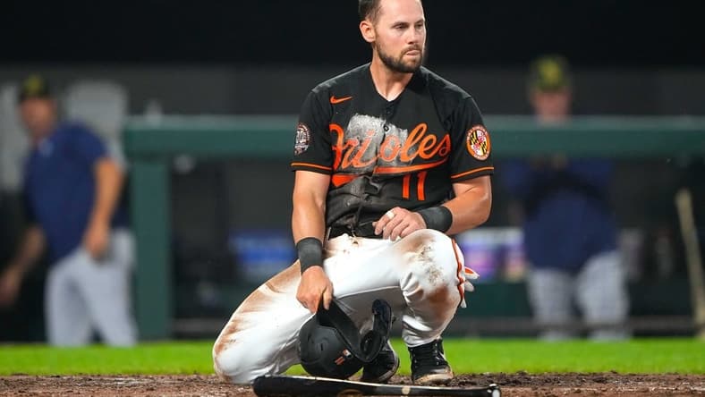 May 20, 2022; Baltimore, Maryland, USA; Baltimore Orioles second baseman Chris Owings (11) reacts to being tagged out a home plate during the fifth inning against the Tampa Bay Rays at Oriole Park at Camden Yards. Mandatory Credit: Gregory Fisher-USA TODAY Sports