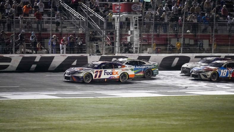 May 29, 2022; Concord, North Carolina, USA; NASCAR Cup Series driver Denny Hamlin (11) takes the lead on the restart in the Coca-Cola 600 at Charlotte Motor Speedway. Mandatory Credit: Jim Dedmon-USA TODAY Sports