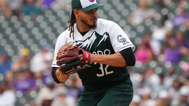 Aug 14, 2022; Denver, Colorado, USA; Colorado Rockies relief pitcher Dinelson Lamet (32) prepares to deliver a pitch in the eighth inning against the Arizona Diamondbacks at Coors Field. Mandatory Credit: Ron Chenoy-USA TODAY Sports