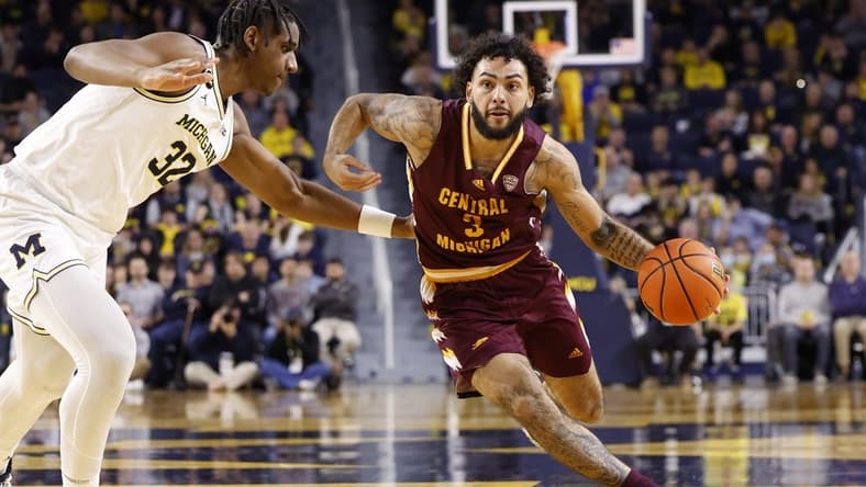 Dec 29, 2022; Ann Arbor, Michigan, USA;  Central Michigan Chippewas guard Jesse Zarzuela (3) dribbles on Michigan Wolverines forward Tarris Reed Jr. (32) in the second half at Crisler Center. Mandatory Credit: Rick Osentoski-USA TODAY Sports