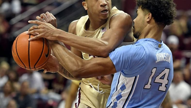 Feb 27, 2023; Tallahassee, Florida, USA; North Carolina Tar Heels forward Donovan Johnson (14) fouls Florida State Seminoles guard Matthew Cleveland (35) during the first half at Donald L. Tucker Center. Mandatory Credit: Melina Myers-USA TODAY Sports