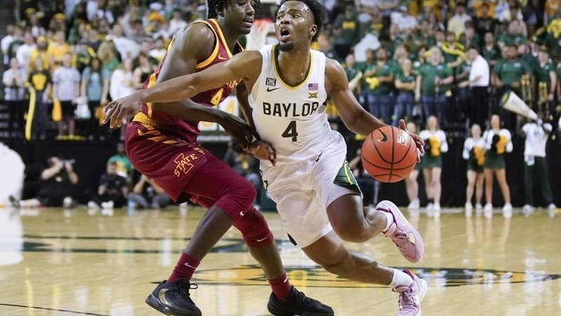 Mar 4, 2023; Waco, Texas, USA; Baylor Bears guard LJ Cryer (4) dribbles around Iowa State Cyclones guard Demarion Watson (4) during the second half at Ferrell Center. Mandatory Credit: Raymond Carlin III-USA TODAY Sports