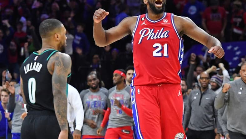 Mar 10, 2023; Philadelphia, Pennsylvania, USA; Philadelphia 76ers center Joel Embiid (21) celebrates win over Portland Trail Blazers guard Damian Lillard (0) at Wells Fargo Center. Mandatory Credit: Eric Hartline-USA TODAY Sports