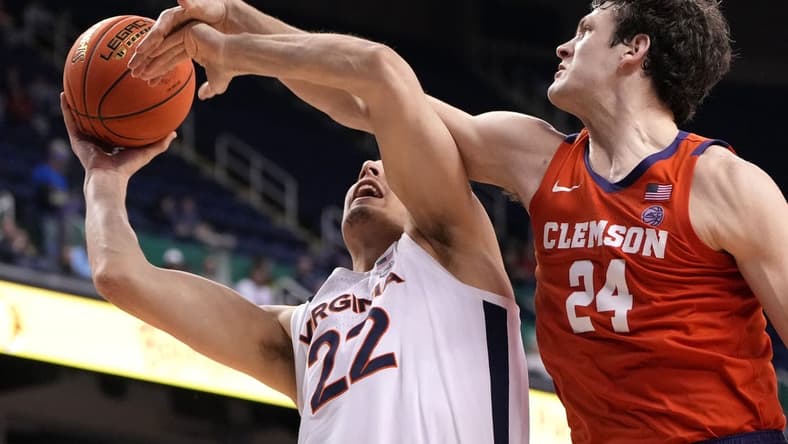 Mar 10, 2023; Greensboro, NC, USA;  Virginia Cavaliers center Francisco Caffaro (22) shoots as Clemson Tigers center PJ Hall (24) defends in the second half during the semifinals of the ACC Tournament at Greensboro Coliseum. Mandatory Credit: Bob Donnan-USA TODAY Sports