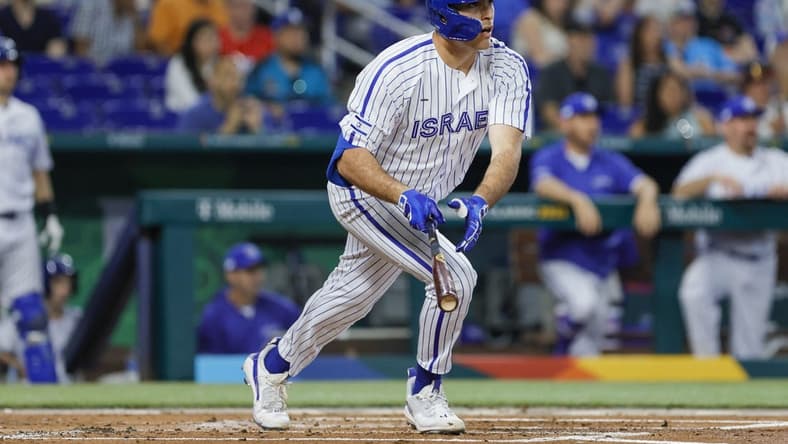 Mar 12, 2023; Miami, Florida, USA; Israel first baseman Matt Mervis (27) hits a single during the first inning against Nicaragua at LoanDepot Park. Mandatory Credit: Sam Navarro-USA TODAY Sports
