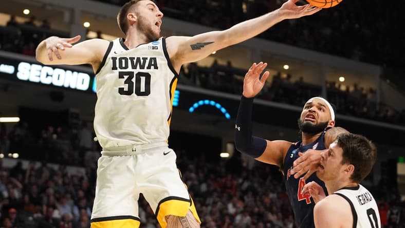 Mar 16, 2023; Birmingham, AL, USA; Iowa Hawkeyes guard Connor McCaffery (30) reaches for a rebound against Auburn Tigers forward Johni Broome (4) during the second half in the first round of the 2023 NCAA Tournament at Legacy Arena. Mandatory Credit: Marvin Gentry-USA TODAY Sports