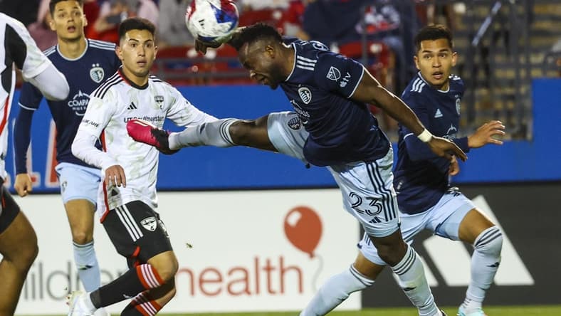Mar 18, 2023; Frisco, Texas, USA; Sporting Kansas City forward Willy Agada (23) heads the ball away from FC Dallas forward Alan Velasco (20) during the match at Toyota Stadium. Mandatory Credit: Kevin Jairaj-USA TODAY Sports
