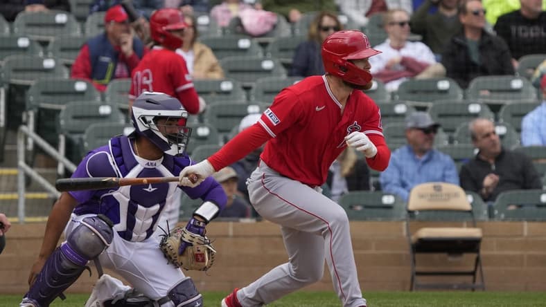 Mar 22, 2023; Salt River Pima-Maricopa, Arizona, USA; Los Angeles Angels first baseman Jared Walsh (20) hits an RBI double against the Colorado Rockies in the fourth inning at Salt River Fields at Talking Stick. Mandatory Credit: Rick Scuteri-USA TODAY Sports