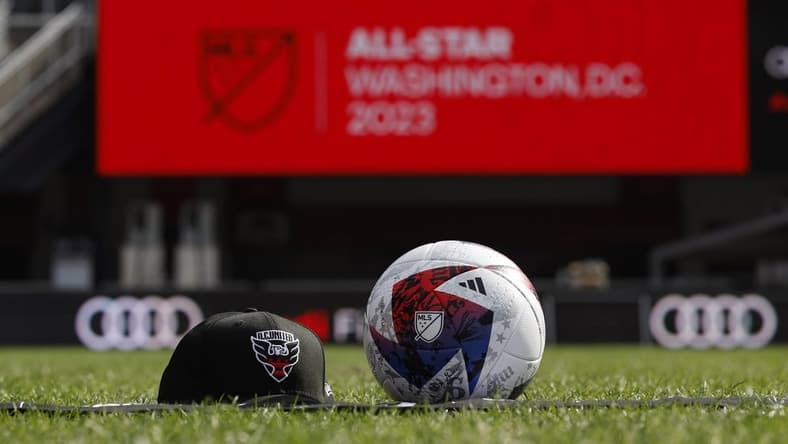 Mar 14, 2023; Washington, DC, USA; A view of a D.C. United hat, an official MLS game ball, and an All Star scarf after an announcement that Premier League club Arsenal will play the MLS All Stars at the MLS All-Star Game in Washington D.C at Audi Field. Mandatory Credit: Geoff Burke-USA TODAY Sports
