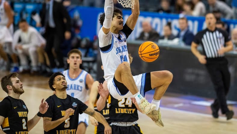 Nova Southeastern's RJ Sunahara (13) dunks the ball as the Nova Southeastern University Sharks play the West Liberty Hilltoppers during the championship game of the 2023 NCAA Division II Men   s basketball tournament at Ford Center in Downtown Evansville, Ind., Saturday afternoon, March 25, 2023.

Mb Ncaadii Championship 02
