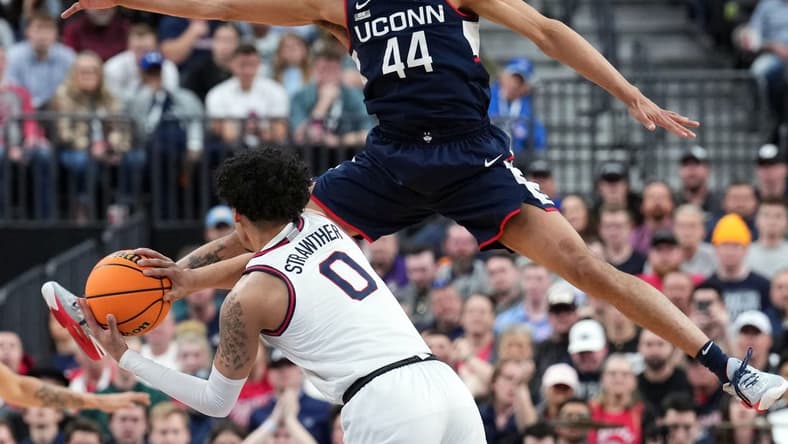 Mar 25, 2023; Las Vegas, NV, USA; Connecticut Huskies guard Andre Jackson Jr. (44) defends against Gonzaga Bulldogs guard Julian Strawther (0) during the second half for the NCAA tournament West Regional final at T-Mobile Arena. Mandatory Credit: Joe Camporeale-USA TODAY Sports at T-Mobile Arena. Mandatory Credit: Joe Camporeale-USA TODAY Sports