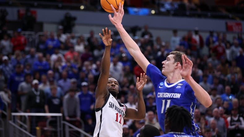 Mar 26, 2023; Louisville, KY, USA;  Creighton Bluejays center Ryan Kalkbrenner (11) blocks a shot at the basket by San Diego State Aztecs guard Darrion Trammell (12) during the second half at the NCAA Tournament South Regional-Creighton vs San Diego State at KFC YUM! Center. Mandatory Credit: Jordan Prather-USA TODAY Sports