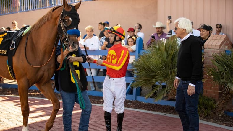 Horse trainer Bob Baffert, right, and jockey Flavien Prat and horse, Hard to Figure , #6, moments before racing in the 18th running of the Sunland Derby at Sunland Park Racetrack & Casino in Sunland Park, New Mexico, Sunday, March 26, 2023.