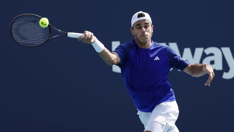 Mar 30, 2023; Miami, Florida, US; Francisco Cerundolo (ARG) hits a forehand against Karen Khachanov (not pictured) in a men's singles quarterfinal on day eleven of the Miami Open at Hard Rock Stadium. Mandatory Credit: Geoff Burke-USA TODAY Sports