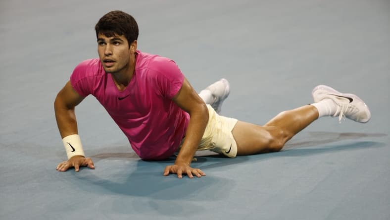 Mar 31, 2023; Miami, Florida, US; Carlos Alcaraz (ESP) falls to the court after diving for a shot against Jannik Sinner (ITA) (not pictured) in a men's singles semifinal on day twelve on the Miami Open at Hard Rock Stadium. Mandatory Credit: Geoff Burke-USA TODAY Sports