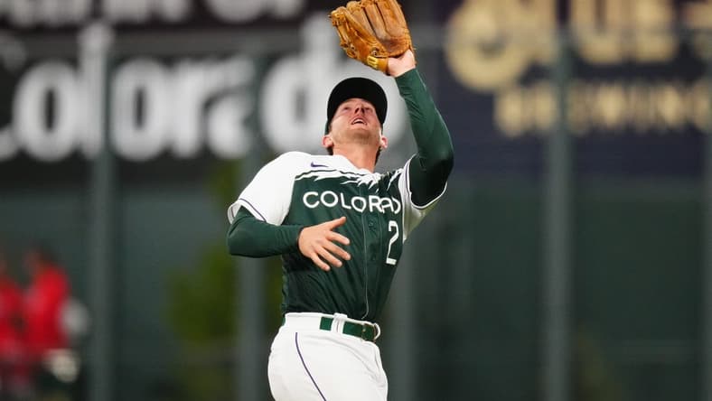 Apr 8, 2023; Denver, Colorado, USA; Colorado Rockies center fielder Yonathan Daza (2) field the ball in the sixth inning against the Washington Nationals at Coors Field. Mandatory Credit: Ron Chenoy-USA TODAY Sports