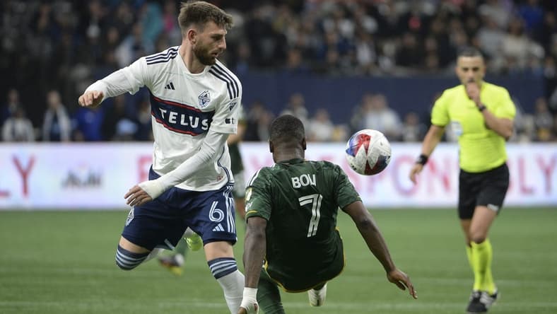 Apr 8, 2023; Vancouver, British Columbia, CAN;  Vancouver Whitecaps FC defender Tristan Blackmon (6) battles for the ball against Portland Timbers forward Franck Boli (7) during the second half at BC Place. Mandatory Credit: Anne-Marie Sorvin-USA TODAY Sports