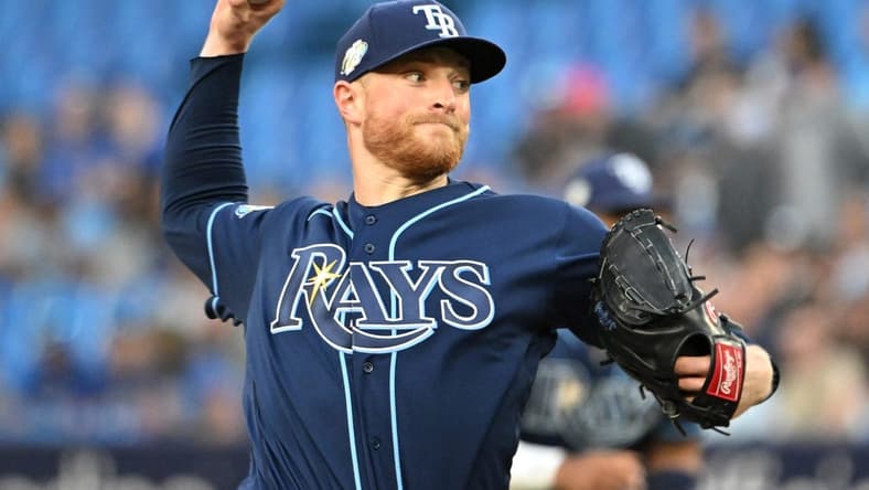 Apr 14, 2023; Toronto, Ontario, CAN;    Tampa Bay Rays starting pitcher Drew Rasmussen (57) delivers a pitch against the Toronto Blue Jays in the first inning at Rogers Centre. Mandatory Credit: Dan Hamilton-USA TODAY Sports