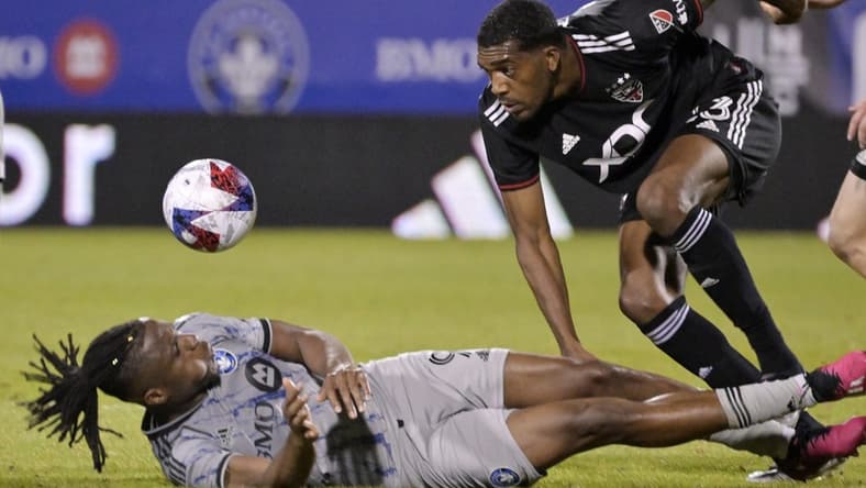 Apr 15, 2023; Montreal, Quebec, CAN; CF Montreal forward Chinonso Offor (9) and D.C. United defender Donovan Pines (23) collide after a head ball during the second half at Stade Saputo. Mandatory Credit: Eric Bolte-USA TODAY Sports