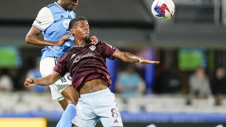 Apr 15, 2023; Charlotte, North Carolina, USA; Charlotte FC defender Adilson Malanda (29) gets the header over Colorado Rapids Max Alves (8) during the second half at Bank of America Stadium. Mandatory Credit: Jim Dedmon-USA TODAY Sports