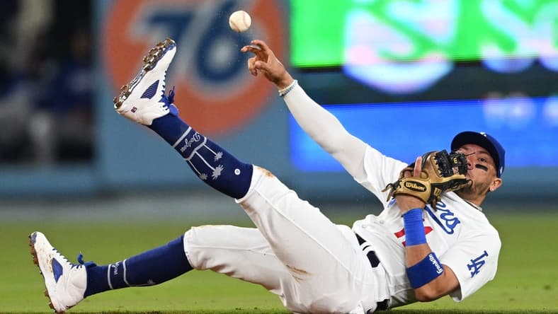 Apr 18, 2023; Los Angeles, California, USA; Los Angeles Dodgers shortstop Miguel Rojas (11) tries to make a play but can   t get New York Mets shortstop Francisco Lindor (12) out at first in the fourth ininng at Dodger Stadium. Mandatory Credit: Jayne Kamin-Oncea-USA TODAY Sports