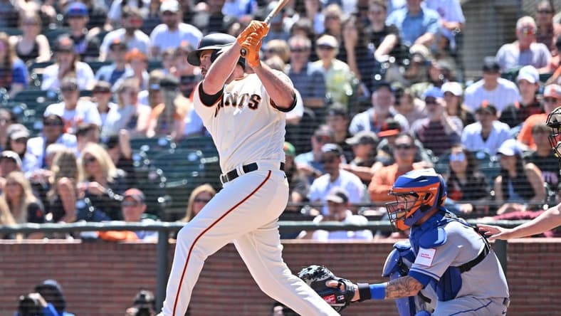 Apr 22, 2023; San Francisco, California, USA; San Francisco Giants designated hitter Darin Ruf (18) hits an RBI single against New York Mets starting pitcher David Peterson (23) during the second inning at Oracle Park. Mandatory Credit: Robert Edwards-USA TODAY Sports