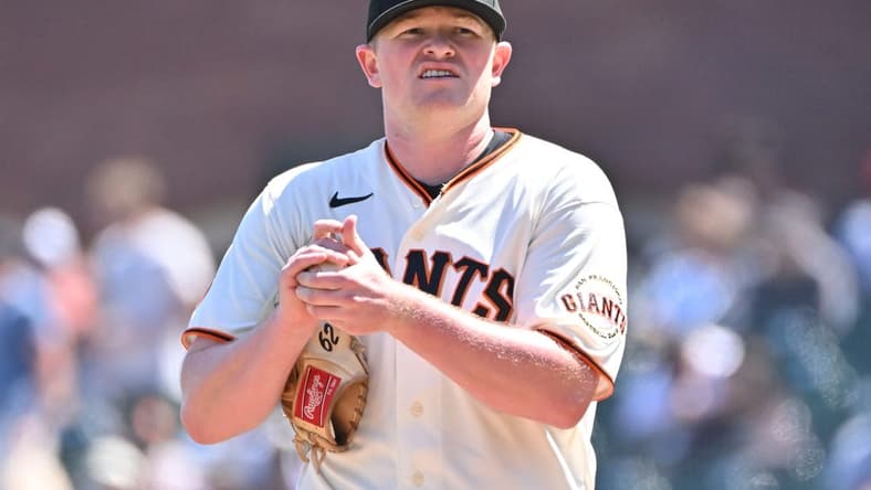 Apr 22, 2023; San Francisco, California, USA; San Francisco Giants starting pitcher Logan Webb (62) rubs up a baseball before the start of the fifth inning against the New York Mets at Oracle Park. Mandatory Credit: Robert Edwards-USA TODAY Sports