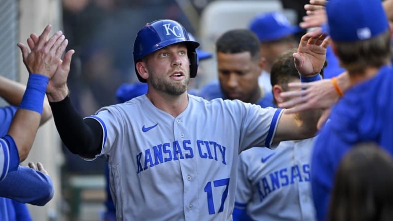 Apr 22, 2023; Anaheim, California, USA; Kansas City Royals third baseman Hunter Dozier (17) is greeted in the dugout after scoring on a single by shortstop Bobby Witt Jr. (7) in the third inning against the Los Angeles Angels at Angel Stadium. Mandatory Credit: Jayne Kamin-Oncea-USA TODAY Sports