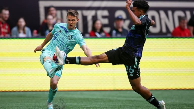 Apr 23, 2023; Atlanta, Georgia, USA; Chicago Fire defender Arnaud Souquet (2) battles for the ball against Atlanta United defender Caleb Wiley (26) during the second half at Mercedes-Benz Stadium. Mandatory Credit: Brett Davis-USA TODAY Sports