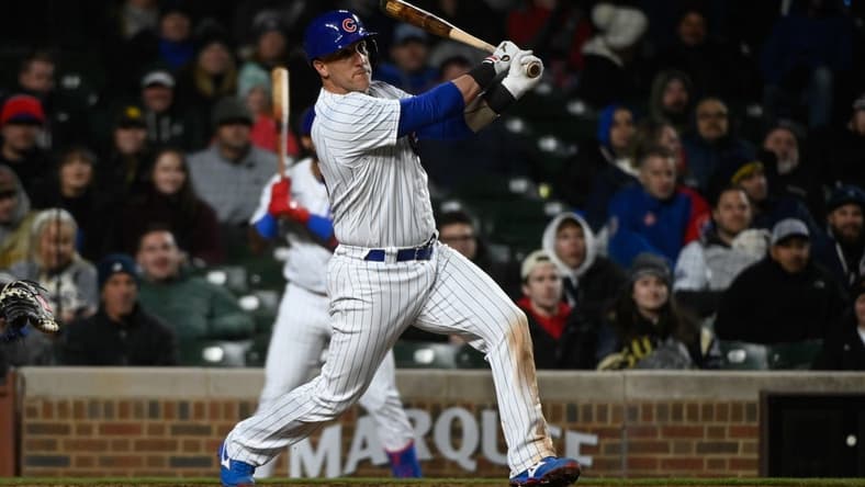 Apr 25, 2023; Chicago, Illinois, USA;  Chicago Cubs catcher Yan Gomes (15) hits an RBI single against the San Diego Padres during the eighth inning  at Wrigley Field. Mandatory Credit: Matt Marton-USA TODAY Sports
