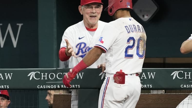 Apr 29, 2023; Arlington, Texas, USA; Texas Rangers shortstop Ezequiel Duran (20) celebrates his two-run home run with manager Bruce Bochy (15) against the New York Yankees during the fifth inning at Globe Life Field. Mandatory Credit: Jim Cowsert-USA TODAY Sports