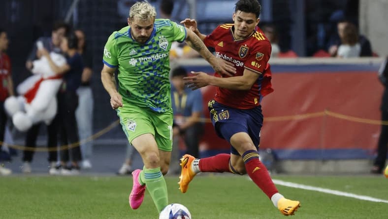 Apr 29, 2023; Sandy, Utah, USA; Seattle Sounders forward Jordan Morris (13) and Real Salt Lake defender Brayan Vera (4) battle in the first half at America First Field. Mandatory Credit: Jeffrey Swinger-USA TODAY Sports