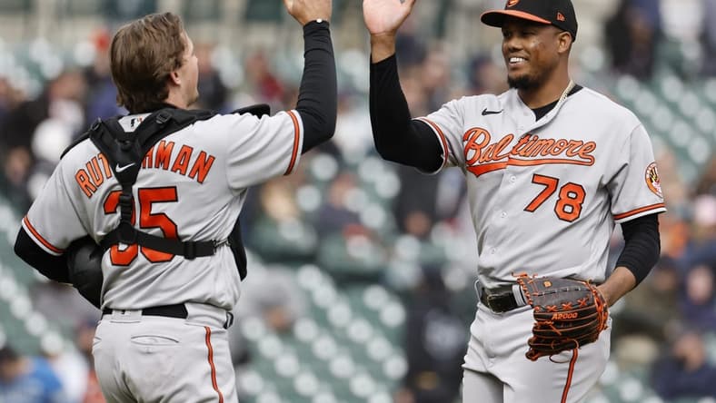 Apr 30, 2023; Detroit, Michigan, USA; Baltimore Orioles catcher Adley Rutschman (35) and relief pitcher Yennier Cano (78) celebrate after defeating the Detroit Tigers at Comerica Park. Mandatory Credit: Rick Osentoski-USA TODAY Sports